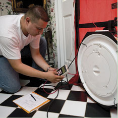 Testing the airtightness of a home using a special fan called a blower door.