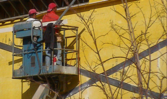Construction workers in aerial lift