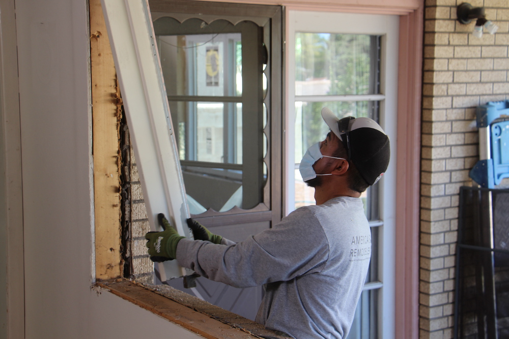 remodeler installing a window during covid-19