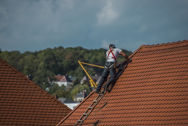 Roofer with harness on rooftop
