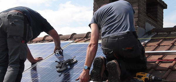 Solar installers working on roof
