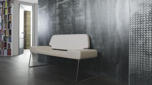 Industrial chic and reclaimed materials, such as the Metalli collection by Laminam