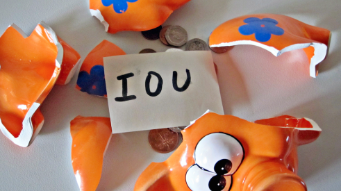 Unpaid invoices and IOU in piggy bank
