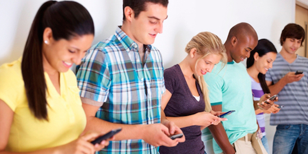Group of youths communicating via text message