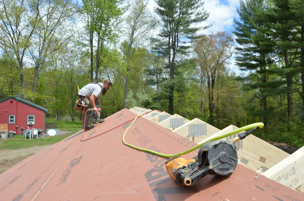 Carpenter ben bogie sheathing the Model ReModel project's roof