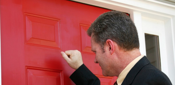 Salesman knocking on door for home improvement sales appointment