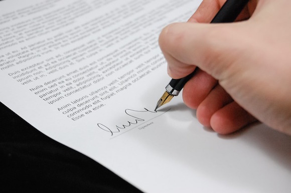 An employee signing a non-compete document.