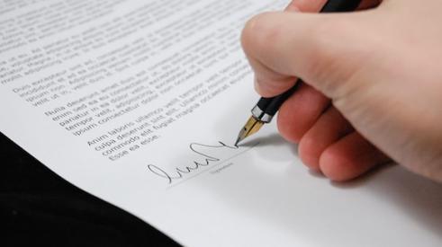 An employee signing a non-compete document.