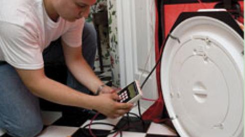 Testing the airtightness of a home using a special fan called a blower door.